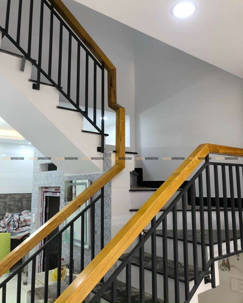 LAN CAN SẮT 54 Mẫu cầu thang lan can sắt tay vịn gỗ.